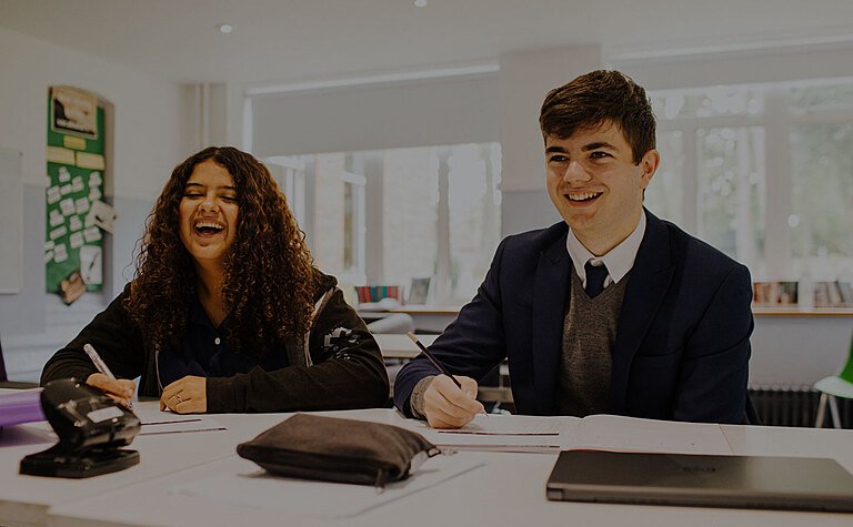 Male and female St Margaret's  School Sixth Form students studying in a classroom