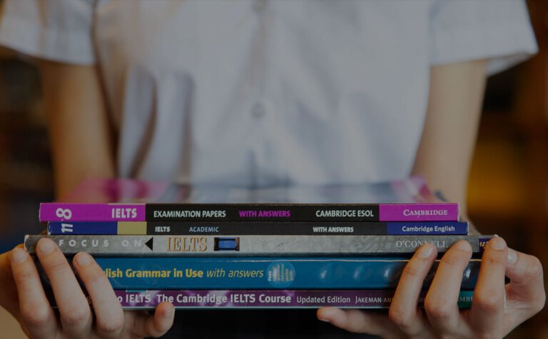 St Margarets School Pupil holding a stack of EAL books