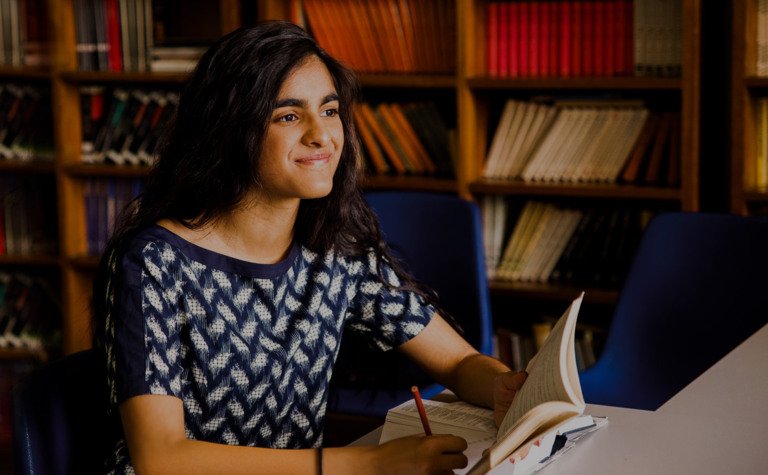 St Margarets School Sixth Form pupil studying in library