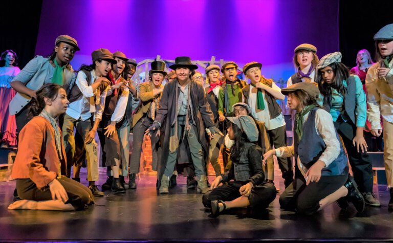 Group of pupils dressed in appropriate costume for a performance at St Margaret's School Bushey sixth form