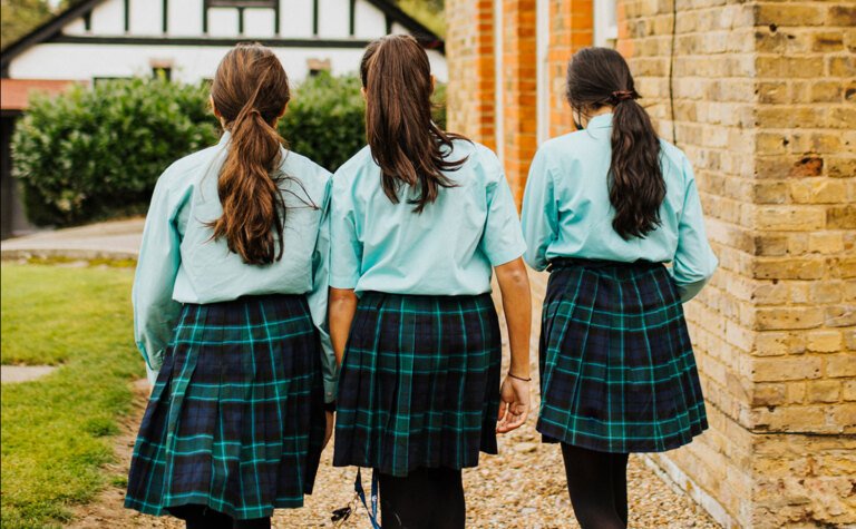 Three senior school pupils enjoying walking outside at St Margaret's School Bushey