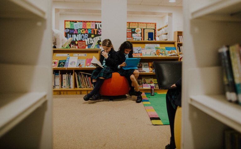 Two upper junior school pupils studying in the library at St Margaret's School Bushey