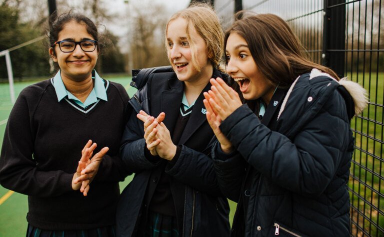 Group of St Margaret's senior school girls clapping and cheering with excitement