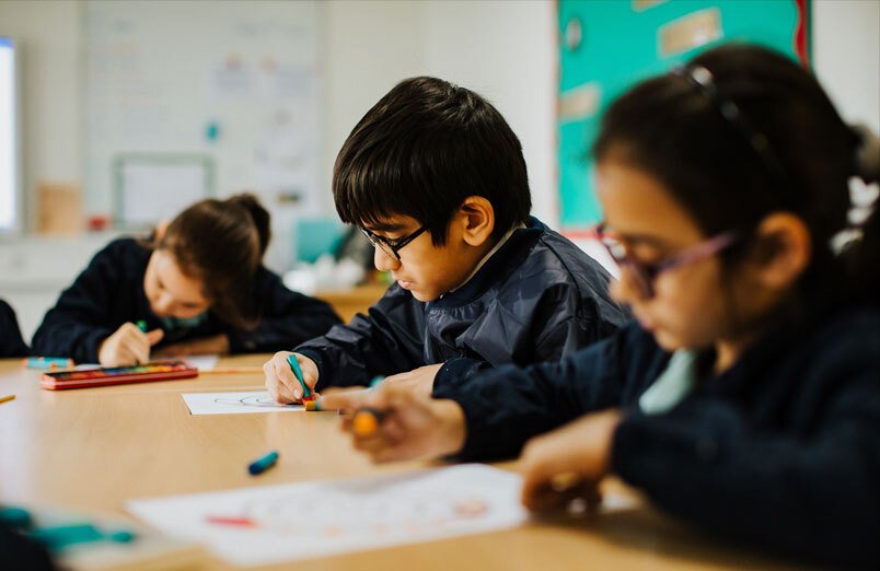 Junior school pupils working in classroom at co-educational school St Margaret's