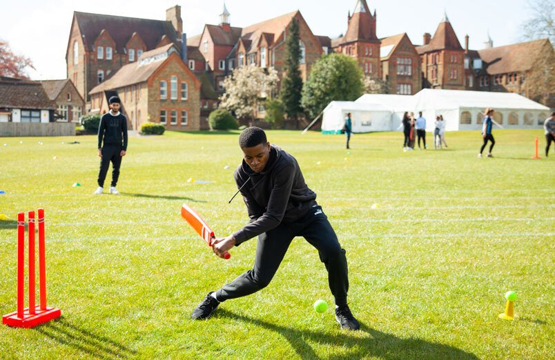 Senior School male pupil at St Margarets School batting for team during a cricket match on a sunny day