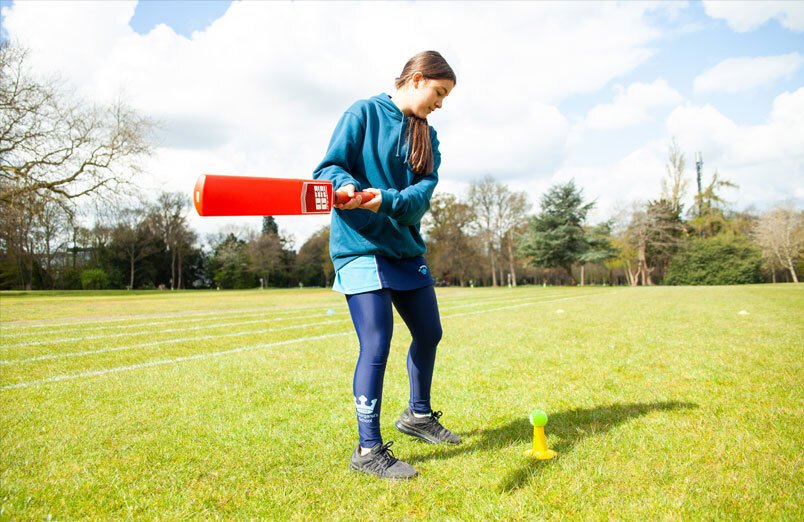 Senior School pupil at St Margarets School practising hitting tennis ball with cricket bat during cricket masterclass