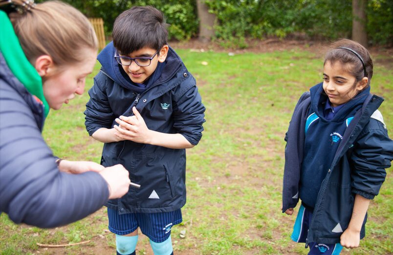 St Margarets School Junior pupils being shown how to create a spark to light a fire