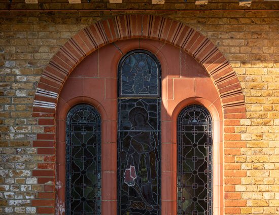 One of the stained glass arched windows of the Waterhouse building at St Margaret's School Bushey