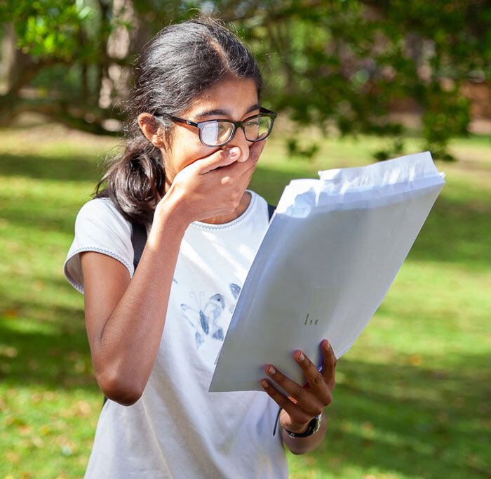 Overwhelmed Senior School pupil from St Margaret's Bushey opening exam results letter