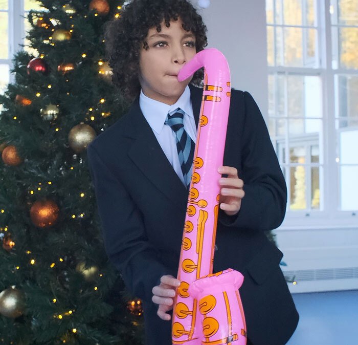 St Margaret's School male pupil playing blow-up saxophone